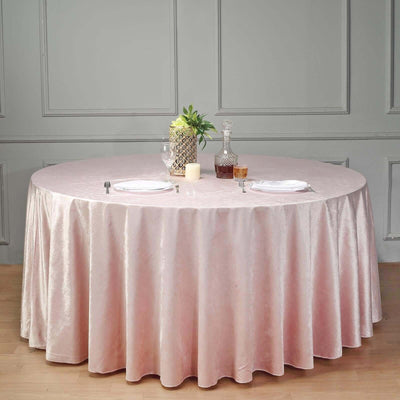 Round pink tablecloth draping over a round table in an elegant setting.