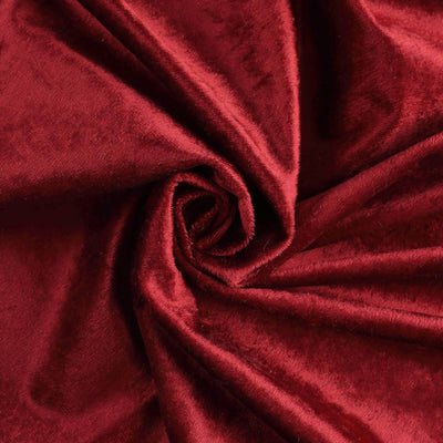 Luxurious deep red velvet fabric texture close-up shot.