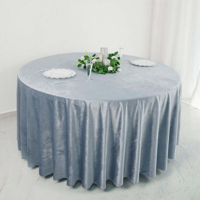Round grey velvet tablecloth with elegant table setting.