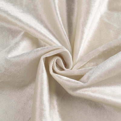 Soft cream velvet fabric texture close-up for upholstery and crafts.