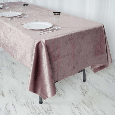 Elegant pink velvet tablecloth draping over a dining table.