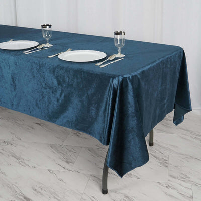 Navy blue tablecloth draped over a table set for dining.