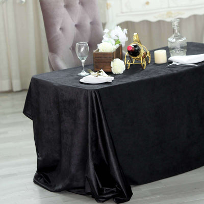 Elegant black tablecloth draped over a table set for dining.