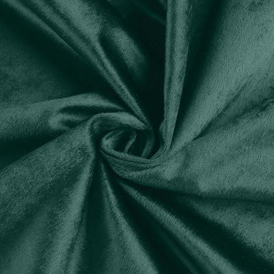 Soft green velvet fabric swirl texture close-up.