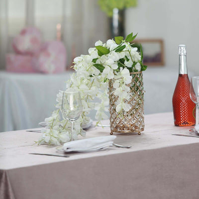 Elegant floral arrangement in a crystal vase on a dining table.