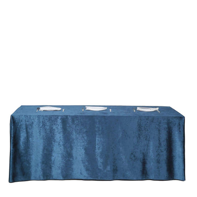 Blue velvet tablecloth draped over a table with plates on top