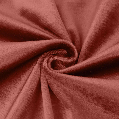 Soft red velvet fabric texture close-up.