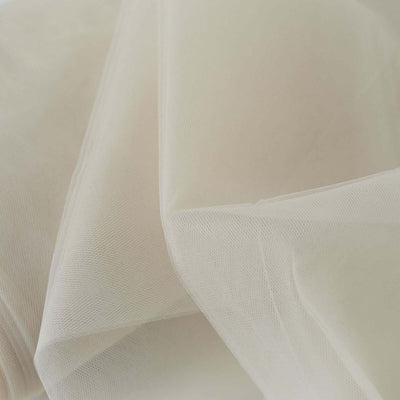 Sheer beige fabric draped elegantly, showcasing texture and softness.