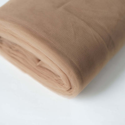 Roll of soft beige fabric on white background