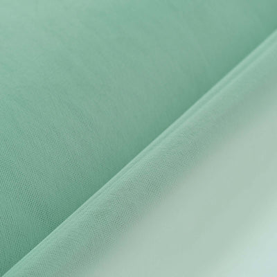 Mint green fabric rolls with textured surface.