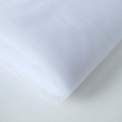 White sheer fabric roll on a plain background