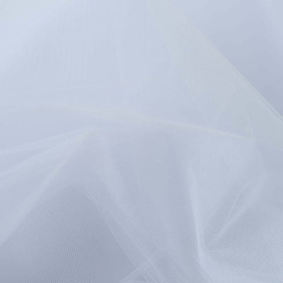 Translucent white tulle fabric draped softly on a pale background.