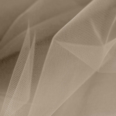 Close-up of soft beige tulle fabric with delicate texture details.