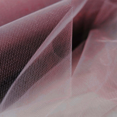 Pink tulle fabric with a delicate netted texture.