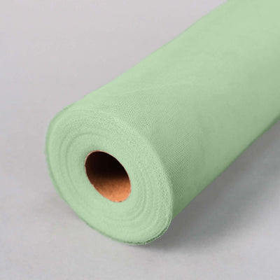 Green tissue paper roll on a neutral background.