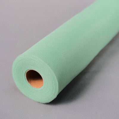 Roll of mint green fabric on a grey surface.