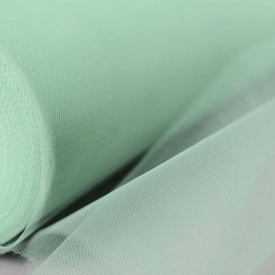 Mint green tulle fabric roll on a light background.