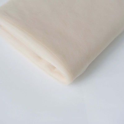 Beige tulle fabric rolled neatly on a plain background.