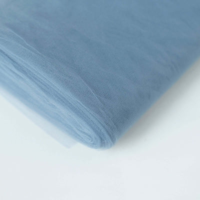 Light blue tulle fabric roll on a plain backdrop.