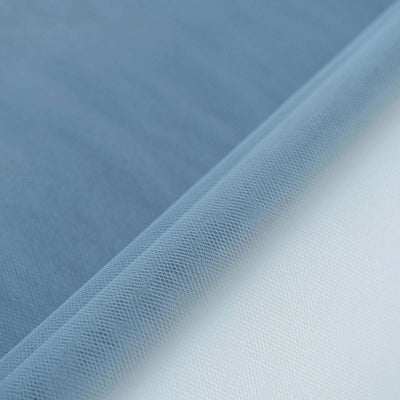 Blue and white textured fabric rolls on a smooth surface.