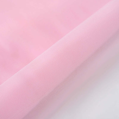 Pink textured fabric close-up on a light background.