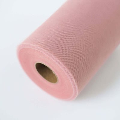 Pink tulle fabric roll on a white background