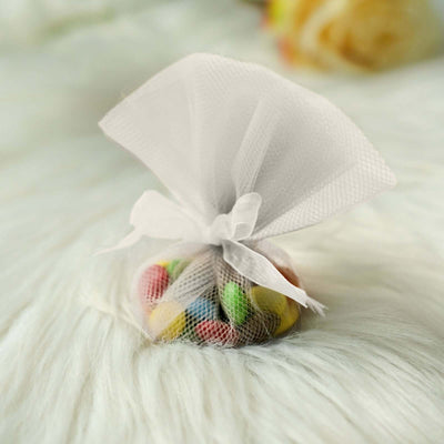 Colorful candy in a decorative mesh bag on soft white fur.