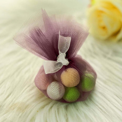 Colorful decorative balls in a purple mesh bag.