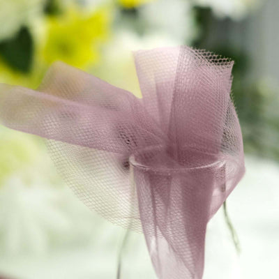 Purple mesh ribbon elegantly tied on a clear glass vase.