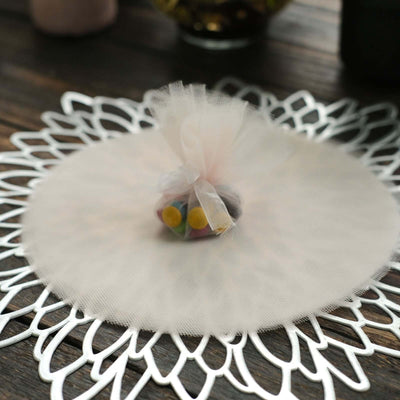 Colorful candy bag wrapped in tulle on a decorative lace platter.