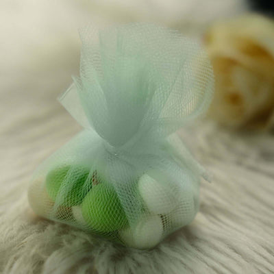 Mint and white candy bag tied with a delicate mesh ribbon.