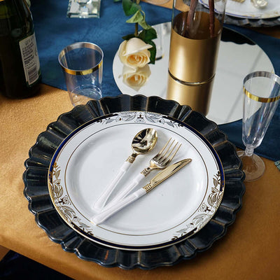 Elegant dinner plate with gold-accented cutlery on a stylish table setting.