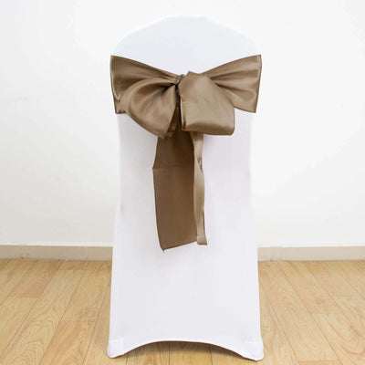 Brown satin chair bow on a white chair.