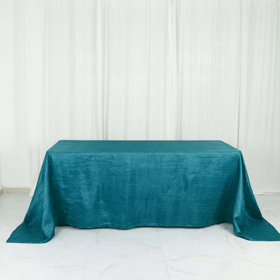 Teal satin tablecloth draped elegantly over a table.