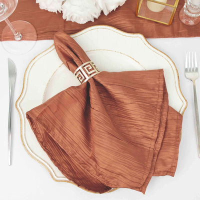 Rustic brown napkin elegantly styled on a decorative plate with cutlery.