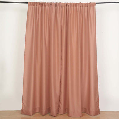 Dusty rose curtain panel hanging on a rod.