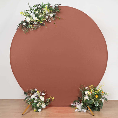 Round backdrop with floral arrangements in front, ideal for photo sessions.