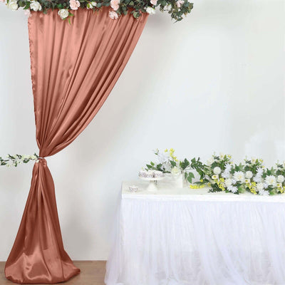 Elegant rose gold drapery with floral arrangement on a table.