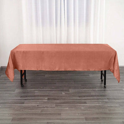 Rust-colored tablecloth draped over a table in a simple setting.