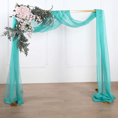 Turquoise drapery with floral arrangement on a wooden frame