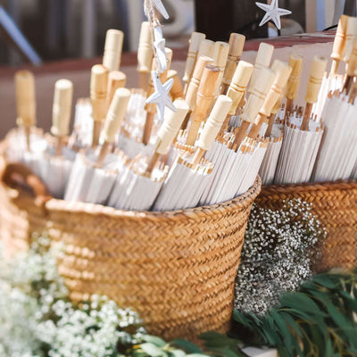 Baskets filled with decorative umbrellas and greenery accents.