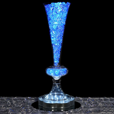 Illuminated crystal vase filled with blue decorative stones
