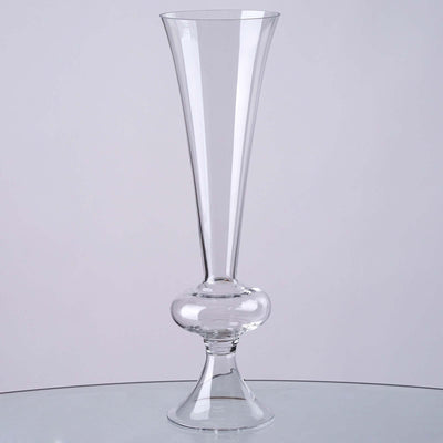 Clear glass vase with a flared top and round base