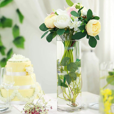 Elegant floral arrangement in a clear vase with greenery and soft pastel flowers.