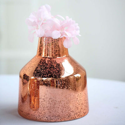 Copper vase with pink flowers.
