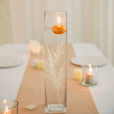 Elegant glass vase with floating candle and decorative plant