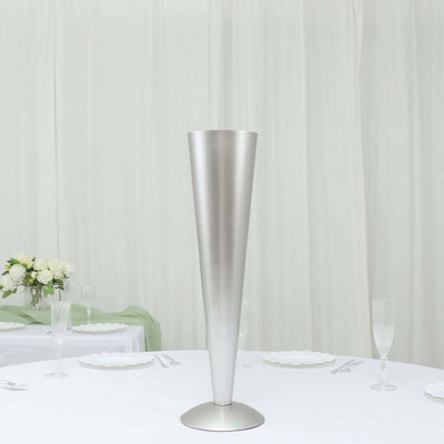 Modern silver cone vase on a table setting with elegant dinnerware.