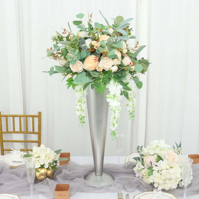 Elegant floral arrangement in a silver vase for tabletop decor.