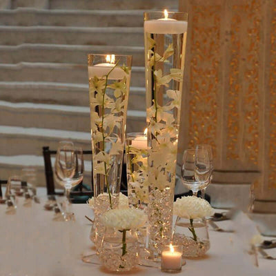 Elegant floral centerpiece with floating candles and crystal accents.