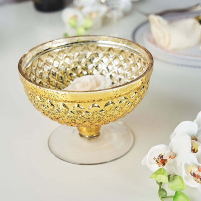 Gold decorative bowl with intricate design and a rose inside.
